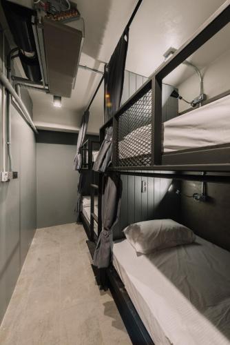 a dorm room with three bunk beds in it at Bed & Bike Hostel in Chiang Rai