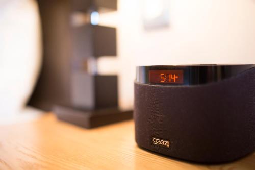an alarm clock sitting on top of a wooden table at Breckland Lodge in Attleborough