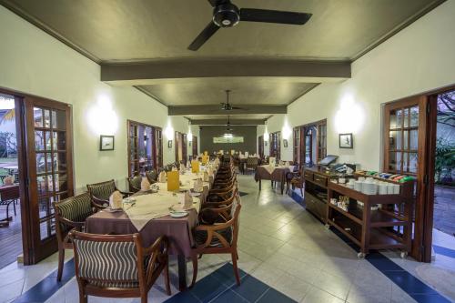 a dining room with tables and chairs in a restaurant at Kithala Resort - Thema Collection in Tissamaharama