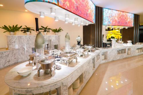 a buffet line in a restaurant with pots and pans at Lake View Hotel in Quy Nhon