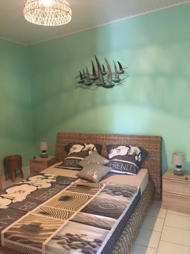 a bedroom with a large bed with pillows on it at Ô Fil de l'Eau in Pointe-Noire