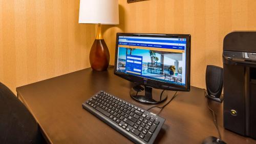 a desk with a computer monitor and a keyboard at Best Western Danville Inn in Danville