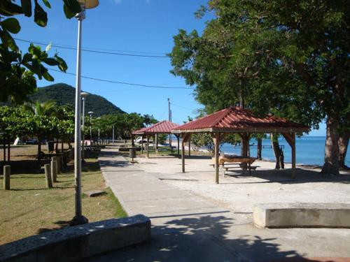 a park with a bench and a pavilion on the beach at Ô Fil de l'Eau in Pointe-Noire