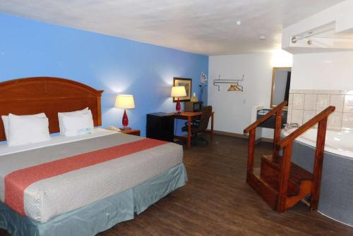 een hotelkamer met een bed en een badkamer bij Days Inn by Wyndham Oklahoma City NW Expressway in Warr Acres