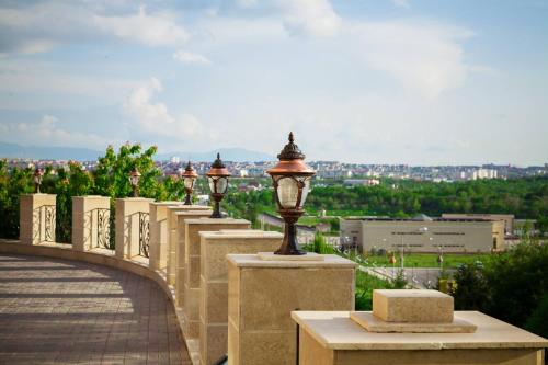 a bridge with street lights and a city in the background at Kainar Hotel in Shymkent