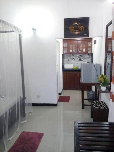 a kitchen with a white refrigerator in a room at Ging View Villa in Galle