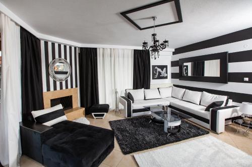 a living room with a couch and a table at Villa Deluxe Sight in Ioannina
