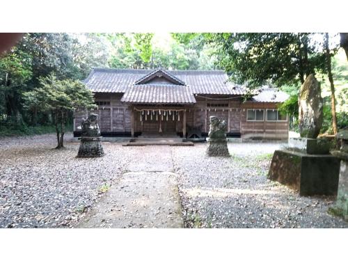 a building with a stone yard in front of it at Hitoyoshi Morinohall Ladies in - Female Only in Hitoyoshi