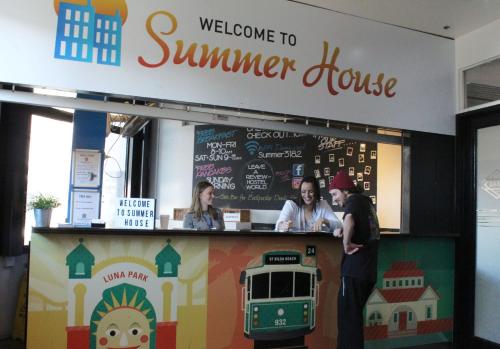 a group of people standing at a welcome to summer house at Summer House Melbourne in Melbourne
