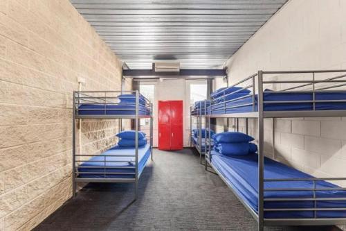 a room with three bunk beds in a building at Summer House Melbourne in Melbourne