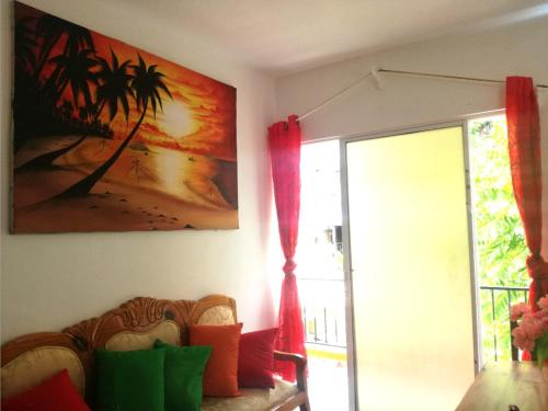 a living room with a couch and a painting on the wall at House Jardin Del Caribe in Las Terrenas