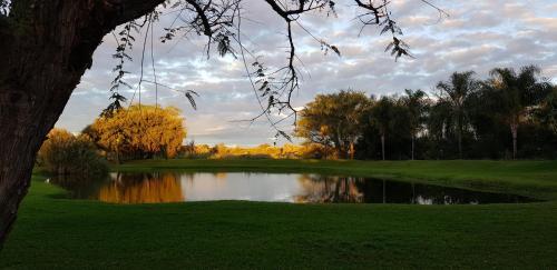 a pond in the middle of a golf course at Machauka Lodge in Lephalale