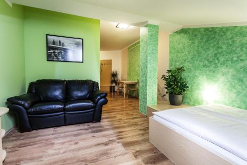 a living room with a bed and a couch at Penzion Pohoda in Trutnov