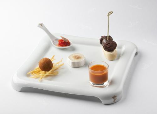a tray with food and a glass of orange juice at Parador de Guadalupe in Guadalupe