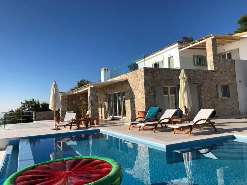 a swimming pool with a watermelon in front of a house at Villa Salina Luxury Pool Villa in Kechria
