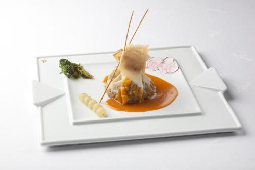 a white plate with food on a white table at Parador de Guadalupe in Guadalupe