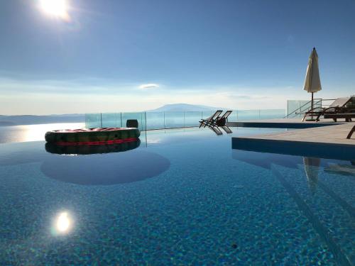 a swimming pool with a view of the water at Villa Salina Luxury Pool Villa in Kechria