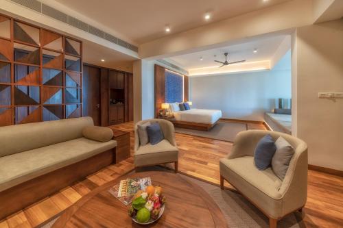 a living room with a couch and chairs and a bedroom at Le Grand Galle in Galle