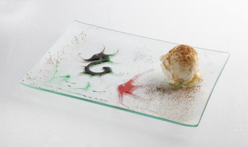 a glass plate with a piece of food on it at Parador de Guadalupe in Guadalupe