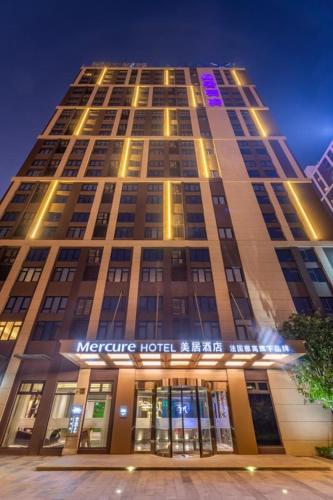 a large building with lights on top of it at Mercure Shanghai Jiuting in Shang-hai