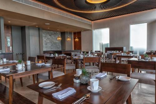 a dining room with wooden tables and chairs at Le Grand Galle in Galle