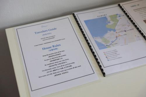 two framed prints of a menu on a wall at Hin Loi Guesthouse in Kota Kinabalu