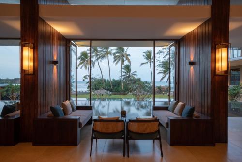a living room with two couches and a table at Le Grand Galle in Galle