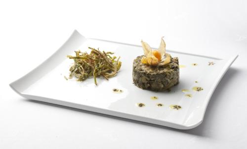 a white plate with a piece of food on it at Parador de Guadalupe in Guadalupe