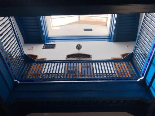 an overhead view of a staircase with a window at Dar Halima in Essaouira