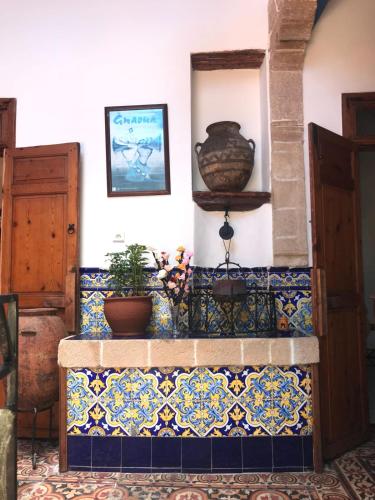 a room with a tile staircase with potted plants at Dar Halima in Essaouira