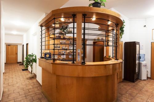 a room with a counter with a shelf of dishes at Penzion Pohoda in Trutnov