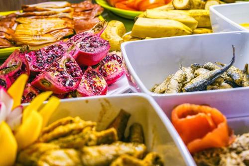 a table topped with trays of different types of food at Fra Mare Thalasso Spa in Haapsalu