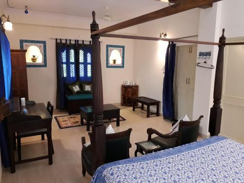 a bedroom with a bed and a living room at Jaswant Niwas in Jodhpur