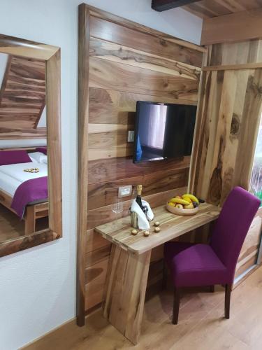 a room with a table and a bed and a mirror at Plitvice Ethno House in Jezerce