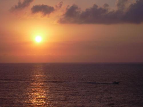 a boat in the ocean at sunset at Borgo Medievale Squillace in Squillace