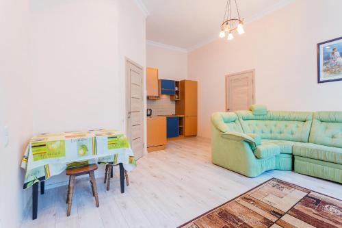 a living room with a couch and a table at Апартаменты на Крещатике in Kyiv