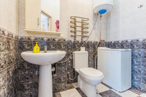 a bathroom with a toilet and a sink at Апартаменты на Крещатике in Kyiv