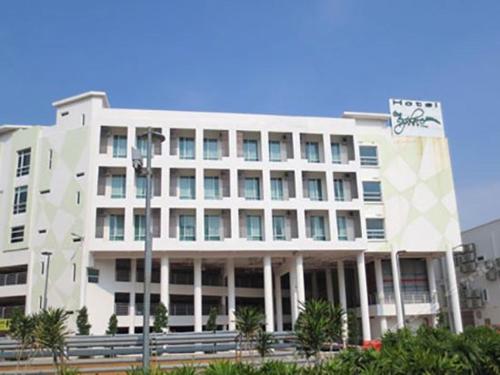 a large white building with a sign on it at The Explorer Hotel in Melaka