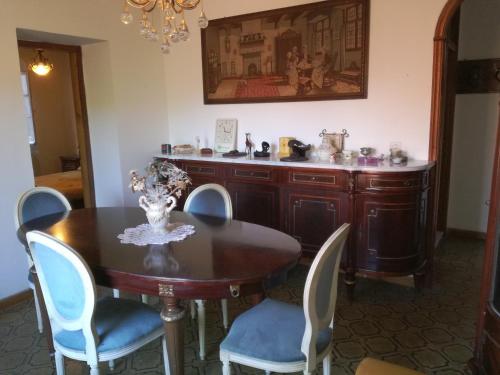 a dining room with a wooden table and chairs at Appartamento nel centro storico di Sassello in Sassello