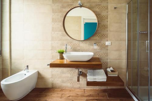 a bathroom with a sink and a mirror at Bluemoon Sardinia in Cagliari