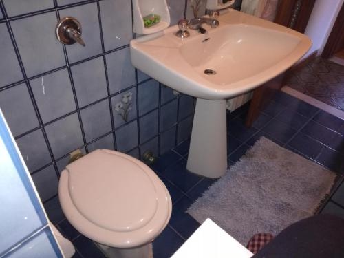 a bathroom with a toilet and a sink at Appartamento nel centro storico di Sassello in Sassello