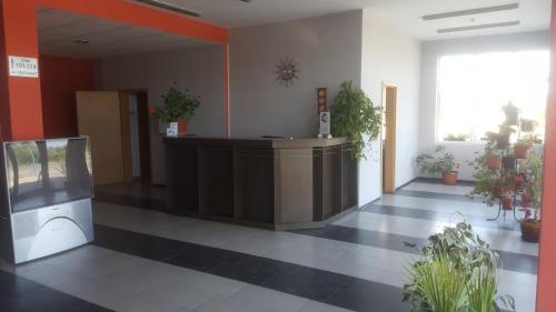 an empty lobby with a reception desk and potted plants at Hotel Seasons 2 in Sunny Beach