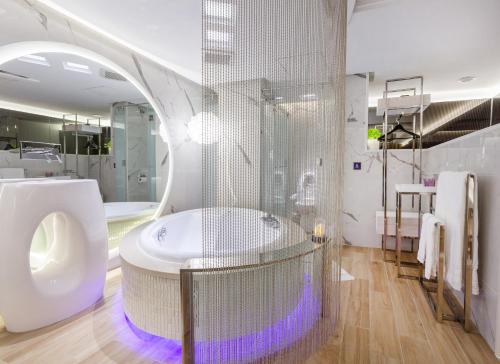 a bathroom with a shower and a toilet and a sink at Chao Motel in Taoyuan