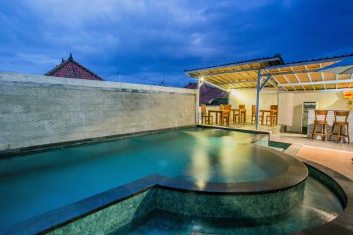a swimming pool in the backyard of a house at D'Yuki Huts Lembongan in Nusa Lembongan