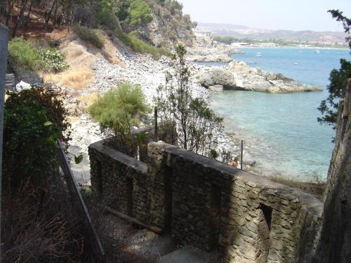 a stone wall next to a body of water at Borgo Medievale Squillace in Squillace
