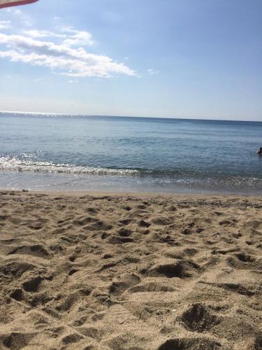 a beach with footprints in the sand and the ocean at Borgo Medievale Squillace in Squillace