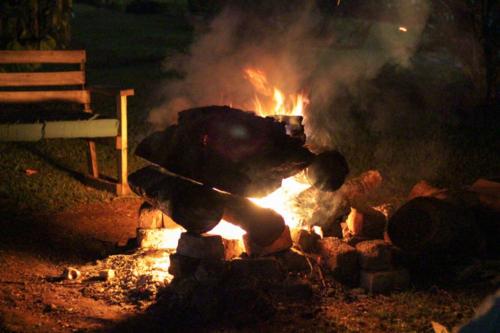 a fire with a teddy bear on top of it at Bushbaby Lodge in Mukono