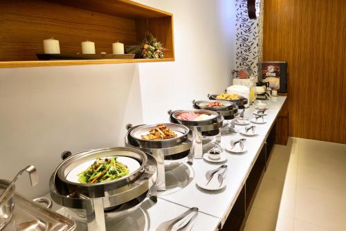 a buffet line with bowls of food on it at OHYA Chain Boutique Motel-Yongkang in Yongkang