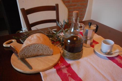 a loaf of bread on a table with a bottle of wine at Agriturismo Lupo Vecchio in Grosseto