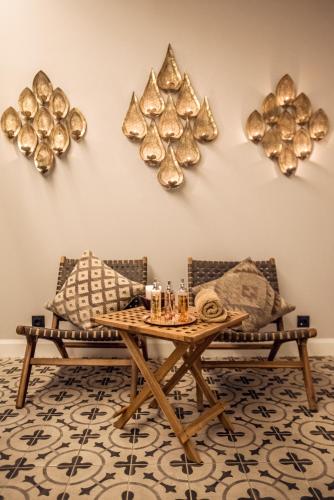 a living room with a table and two chairs at Nido, Mar-Bella Collection in Agios Ioannis Peristeron